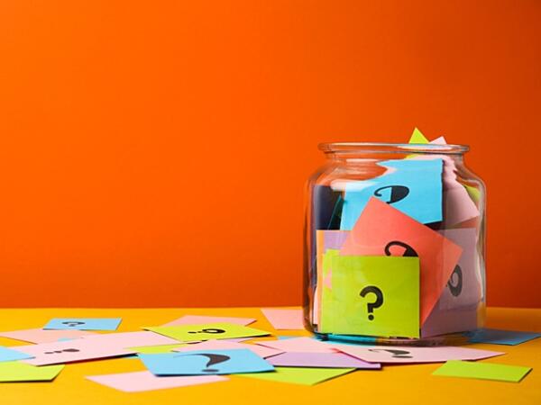 question marks on colourful cue cards in jar